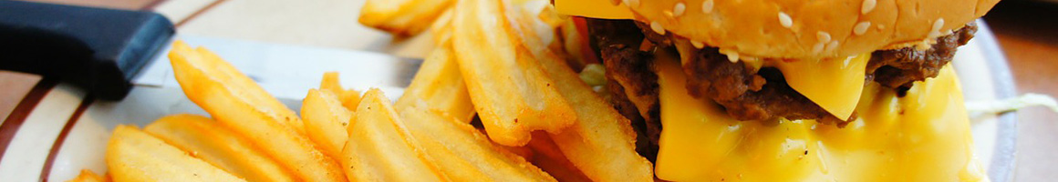 Eating Burger Sandwich Cheesesteak at Joe's Philly Cheesesteak restaurant in Sandpoint, ID.